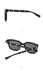 Detail view of black square sunglasses featuring golden bamboo shaped metal temples