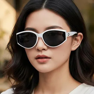 Retro cat-eye sunglasses with white frame and dark lenses worn by a female model