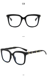 Detail view of large black frames with unique bamboo-style temples and gold metal accents