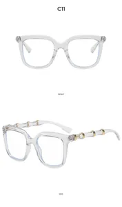 Front and side views of transparent square glasses with unique bamboo-style gold details