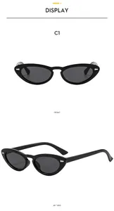 Detail view of retro oval sunglasses with glossy black frames and dark grey lenses