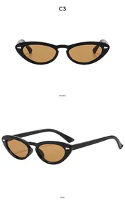 Detail view of oval retro sunglasses with silver rivets and amber lenses from front and side