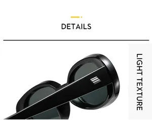 Detail of black oval sunglasses showing wide temples with silver metallic diagonal accents