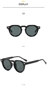 Vue détaillée de lunettes de soleil rondes vintage à monture noire et rivets en diamant argent