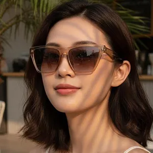 Women's vintage oversized square sunglasses with translucent tea frames and brown gradient lenses