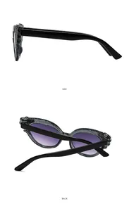Detail view of cat eye kids sunglasses with glitter frame and purple gradient lenses
