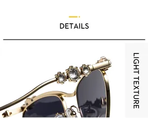 Detailansicht der goldfarbenen Metallsonnenbrille mit Strassbesatz und dunklen Gläsern