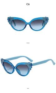 Front and side view of kids' blue glitter cat-eye sunglasses with silver wing accents