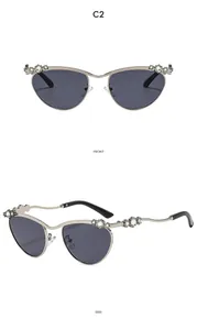 Detail von Katzenaugen-Sonnenbrille mit silbernem Metallrahmen und funkelnden Strasssteinen