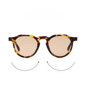 Detailed view of retro oval sunglasses with tortoiseshell frame and amber lenses