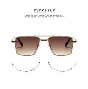 Detail of pilot sunglasses showing golden metal double bridge and gradient brown lenses