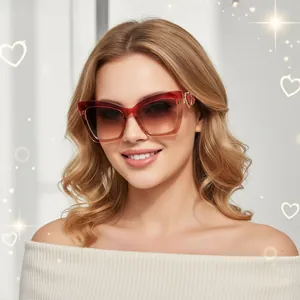 Detail of red cat eye sunglasses featuring gold heart-shaped metal temple accents