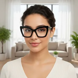 Front view of model wearing large black cat-eye frames with elegant gold temple accents