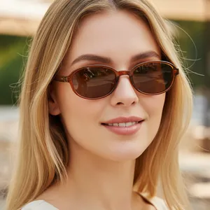 Vintage oval small frame sunglasses in dark amber with brown lenses on model