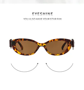 Vue détaillée de lunettes de soleil œil-de-chat rétro avec monture écaillée et verres bruns
