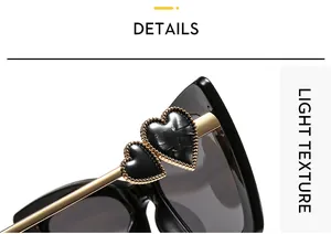 Close-up of black cat-eye frame with gold metal temples and beaded heart accents