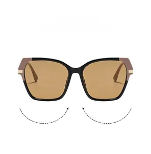 Detail view of retro square cat-eye sunglasses with gold accents and brown tinted lenses