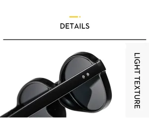 Detail of vintage oval sunglasses with double rivet hinges and light texture black frames