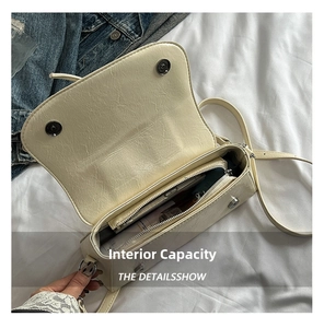 Detail view of the beige crossbody bag interior with zip pocket and daily essentials