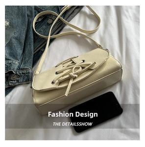 Detailed view of the off-white PU leather crossbody bag featuring a unique bow ribbon design