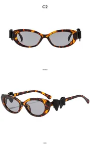 Vues de face et de profil de lunettes œil de chat écaillé avec nœud noir chic