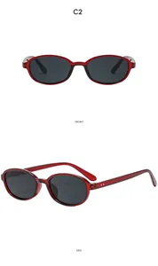 Front and side views of vintage oval sunglasses with transparent red frames and dark lenses
