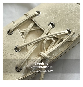 Macro shot of beige leather texture with lace-up straps and silver metal grommet details