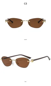 Detail view of rimless vintage sunglasses with gold floral metal hinges and C3 brown lenses