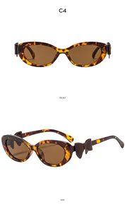 Détail de lunettes de soleil œil-de-chat écaille rétro avec nœud 3D latéral décoratif