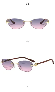 Detail view of rimless gradient purple lenses with ornate gold floral hinges and wood grain arms