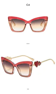 Front and side view of cat-eye sunglasses with red-brown gradient and gold metal temples