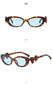 Lunettes œil-de-chat avec monture écaille, verres bleus et détail nœud marron foncé