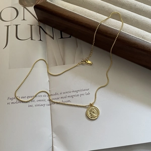 Detail of S925 silver gold-plated queen coin pendant with adjustable beaded chain