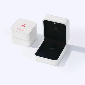 Minimalist white jewelry ring box with black velvet lining and integrated LED spotlight