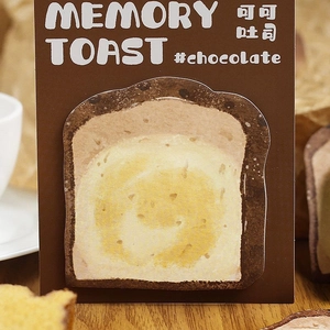 Detail of creative chocolate toast memo pad on a warm breakfast-themed setting