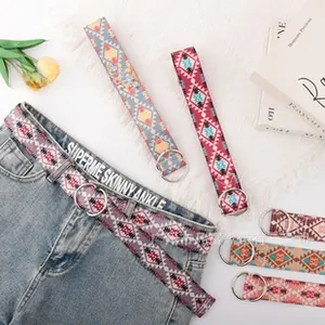 Close-up of bohemian geometric patterns on thick woven canvas strap with D-ring metal buckle