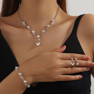 Detail of bridal jewelry set with pearls and rhinestones on a female model