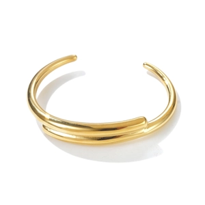 Detail of minimalist gold-plated open cuff bracelet with sleek double-layer streamlined design
