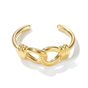 Detailed view of polished golden knot cuff bracelet with elegant intertwined texture