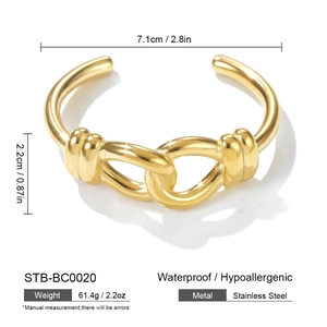 Detail view of gold stainless steel open bangle with hollow twisted texture and dimensions