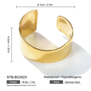 Detailed view of wide gold stainless steel bangle with dimensions 6.1cm by 4.0cm