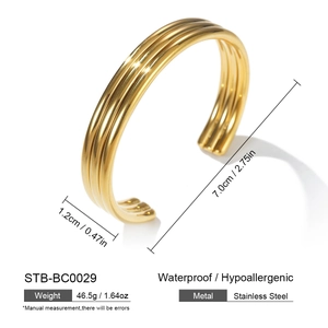 Macro shot of three-layer gold stainless steel open bangle with hollow geometric texture