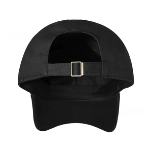 Detail of adjustable metal buckle and strap on back of black cotton baseball cap