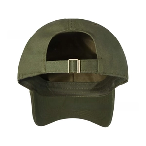 Detail of adjustable metal buckle and fabric strap on dark green vintage baseball cap
