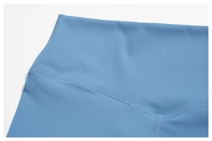 Detailed close-up of sky blue high waisted yoga shorts with professional flatlock stitching