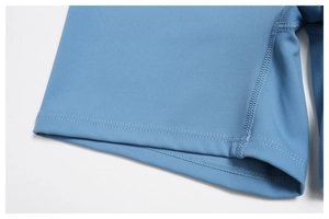 Macro detail of high-elastic blue yoga shorts showing flatlock stitching and knit fabric