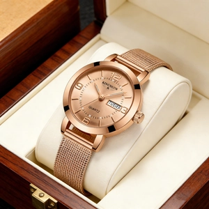 Detailed close-up of rose gold quartz watch with dual calendar display in luxury wood box
