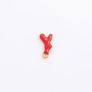 Detailed view of a red coral-like enamel pendant with a gold loop for DIY jewelry making