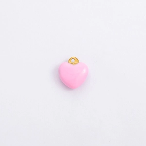 Detailed view of pink enamel heart pendant with gold metal ring for DIY jewelry making