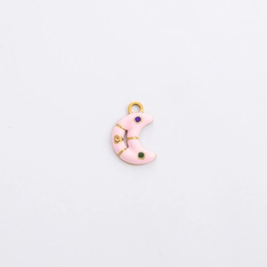 Detail of moon-shaped gold charm with pink enamel inlay and colorful tiny crystals